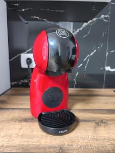 a red blender sitting on top of a wooden floor at Vila Azzuro in Žusterna