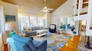 a living room with blue chairs and a couch at 611 Magnolia-Stella Maris in Edisto Island
