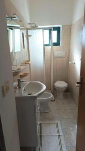 a bathroom with a sink and a toilet at Villa Petrusa in Stromboli