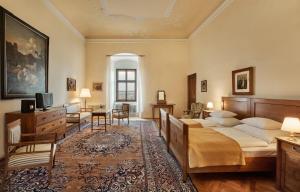 a bedroom with two beds and a table and chairs at Schloss Drosendorf in Drosendorf Stadt