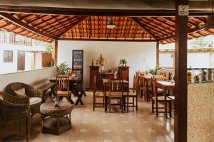 a restaurant with tables and chairs in a room at Pousada Piratininga in Niterói