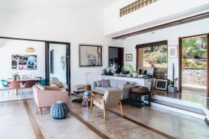 a living room with chairs and a table at Villa Baki - Luxe & Ocean View in Le Morne