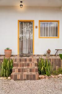 a front door of a home with a brick staircase at Sabiá Hospedagem - São Jorge in Sao Jorge