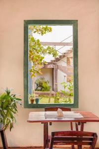 a mirror on a wall next to a wooden table at Sabiá Hospedagem - São Jorge in Sao Jorge +38 photos