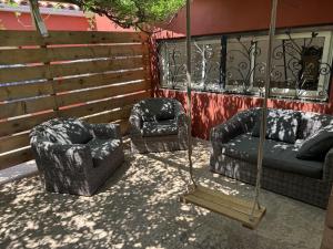 two chairs and a swing on a patio at Chambres d'Hôtes Terra Bella in Lecci