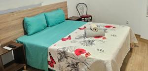 a bed with a blue comforter with a laptop on it at Golden Tower Rooms - auto check-in in Gandía