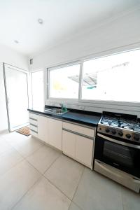 a kitchen with a stove top oven next to a window at Casa Iturraspe in Reconquista