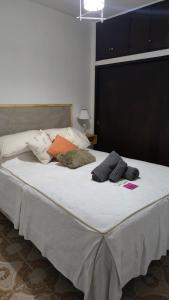a bed with two pillows on top of it at Monoambientes Peatonal - con cochera in Corrientes