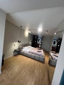 a large bedroom with a bed and a mirror at Перлина Франківська in Ivano-Frankivsk