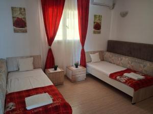 a living room with two beds and a couch at Maison Amina Villa Novel in Triffa