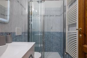 a bathroom with a shower and a toilet and a sink at Mandela Stadium Apartment in Florence
