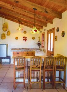 a kitchen with a wooden table and chairs at Cabaña Andrea y Sofía in Mazamitla