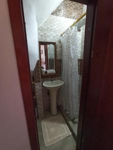 a bathroom with a sink and a mirror at Home Capybara Stay in Mindo +42 photos