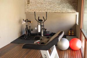 a gym with some exercise equipment in a room at San Marino Suite Hotel in Maceió +59 photos