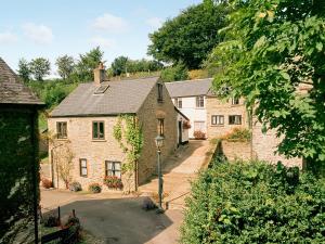 a group of stone houses in a village at Juniper - 28060 in Wheddon Cross