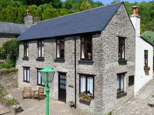 a large stone house with a green street light at Juniper - 28060 in Wheddon Cross +12 photos