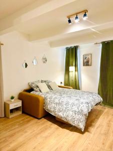 a bedroom with a bed and green curtains at Studio neuf en hyper centre, moderne et calme in Toulon