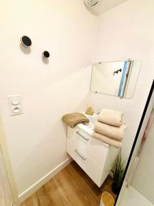 a white bathroom with a sink and a mirror at Studio neuf en hyper centre, moderne et calme in Toulon