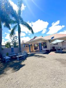 a building with a picnic table and a palm tree at Oasis Residence in Arusha