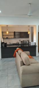 a living room with a couch and a kitchen at Nyali luxe 1 bedroom in Nyali