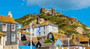 a town with a castle on top of a hill at Coastal Nest in Hollington