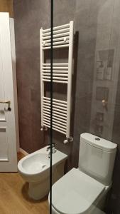 a bathroom with a white toilet and a sink at RC vacanze interno 57 in Rocca di Mezzo