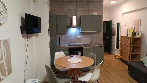 a small kitchen with a table and chairs in a room at RC vacanze interno 57 in Rocca di Mezzo