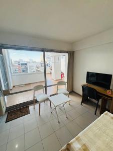 a hotel room with a bed and a piano and a room with a view at Departamento La Merced in Córdoba