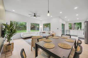 a kitchen and living room with a table and chairs at Ember & Oak - Modern Retreat Near Downtown - Pets in St. Augustine