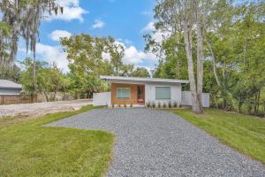 a home with a gravel driveway at Ember & Oak - Modern Retreat Near Downtown - Pets in St. Augustine