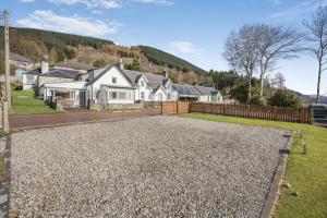 a driveway with gravel in front of a house at 3 Bed in Lochearnhead oc-c33641 in Lochearnhead