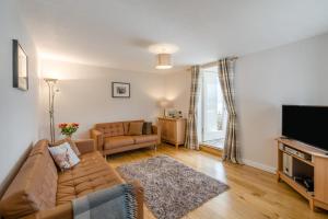 a living room with a couch and a flat screen tv at 3 Bed in Lochearnhead oc-c33641 in Lochearnhead