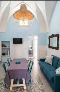 a living room with a table and a couch at Piazza Verdi Liberty House in Lecce