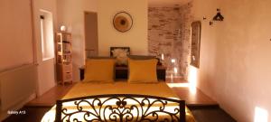 a room with a couch and a table with yellow pillows at Lieu-dit Plaisance in Puygouzon-et-Montsalvy