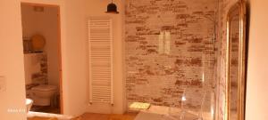 a bathroom with a wall covered in graffiti at Lieu-dit Plaisance in Puygouzon-et-Montsalvy