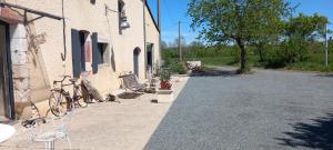 a building with a bike parked next to a street at Lieu-dit Plaisance in Puygouzon-et-Montsalvy