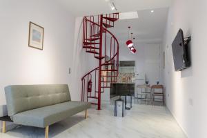 a living room with a couch and a spiral staircase at EVE's house 6 - Corinth center loft in Korinthos
