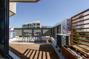 a balcony with a table and chairs on it at EVE's house 6 - Corinth center loft in Korinthos