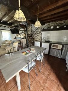 a kitchen and dining room with a table and chairs at Casa La Palomba in Cudillero +29 photos
