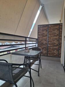 a balcony with a table and two chairs at Central Home in Kalamata +21 photos