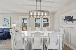 a white dining room with a white table and chairs at CAC-17A - Sailfish in Buxton