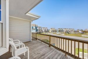 a balcony with two chairs and a view of the ocean at CAC-17A - Sailfish in Buxton