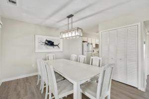 a white dining room with a white table and chairs at CAC-17A - Sailfish in Buxton +38 photos