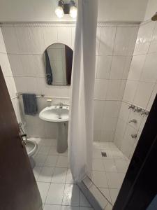 a bathroom with a shower and a sink at Departamento La Merced in Córdoba +11 photos