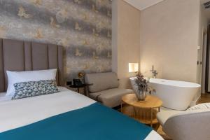 a hotel room with a bed and a bath tub at Golden City Boutique Hotel Tirana in Tirana
