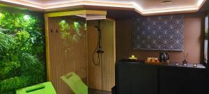 a bathroom with a shower and a sink at GreenHouse pool & spa in Otruševec