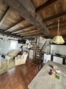 a kitchen and living room with a table and chairs at Casa La Palomba in Cudillero