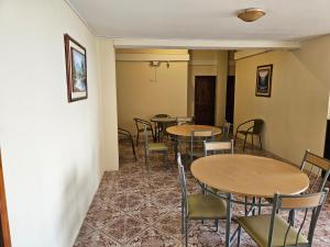 a row of tables and chairs in a room at Hostal Haziel in Salinas