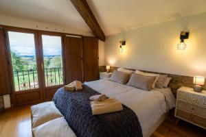 a bedroom with a large bed and a balcony at El Caracol azul del Plano in Siero
