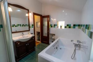 a bathroom with a tub and a sink and a mirror at El Caracol azul del Plano in Siero +27 photos